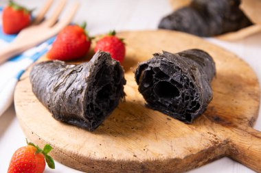 Croissant made with activated charcoal. Vegan breakfast.