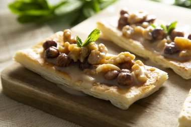 Delicious French dessert made with puff pastry filled with nuts and raisins.