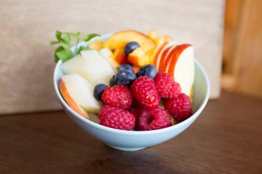 Breakfast bowl with assorted fruit with berries, mango and kiwi.