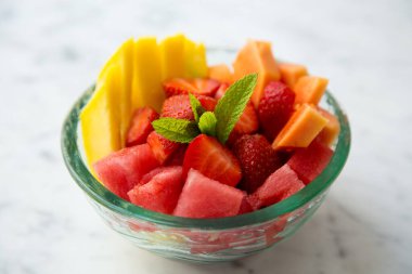 Breakfast bowl with assorted fruit with berries, mango and kiwi.