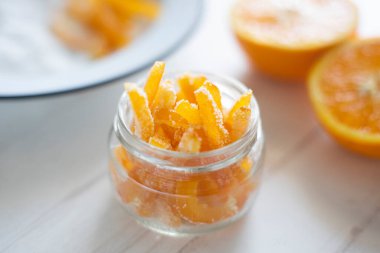 Candied orange sticks in sugar served in a glass.