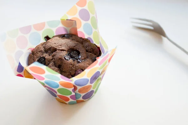 Chocolate muffins with chocolate chips inside.