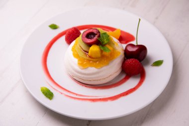 Baked meringue pie filled with fresh fruit.