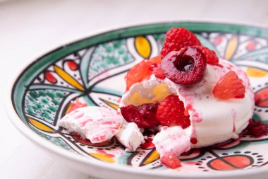 Baked meringue pie filled with fresh fruit.