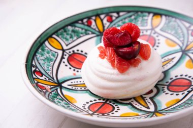 Baked meringue pie filled with fresh fruit.