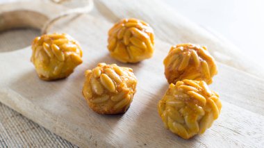 Penellets. Small sweets of various shapes, made from almond and potato dough, and covered with almonds or pine nuts.