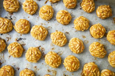 Penellets. Small sweets of various shapes, made from almond and potato dough, and covered with almonds or pine nuts.