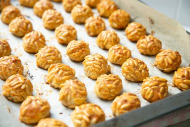 Penellets. Small sweets of various shapes, made from almond and potato dough, and covered with almonds or pine nuts.