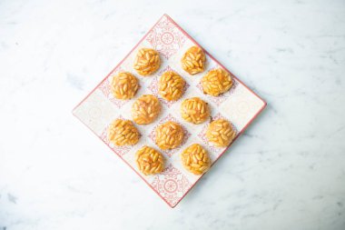 Penellets. Small sweets of various shapes, made from almond and potato dough, and covered with almonds or pine nuts.