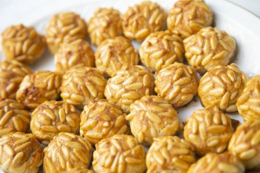 Penellets. Small sweets of various shapes, made from almond and potato dough, and covered with almonds or pine nuts.