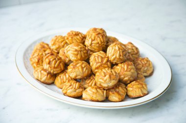 Penellets. Small sweets of various shapes, made from almond and potato dough, and covered with almonds or pine nuts.