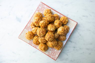 Penellets. Small sweets of various shapes, made from almond and potato dough, and covered with almonds or pine nuts.