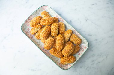 Penellets. Small sweets of various shapes, made from almond and potato dough, and covered with almonds or pine nuts.