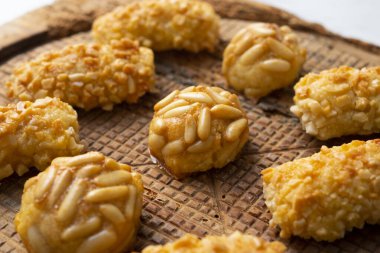 Penellets. Small sweets of various shapes, made from almond and potato dough, and covered with almonds or pine nuts.