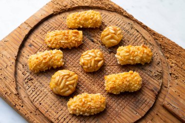 Penellets. Small sweets of various shapes, made from almond and potato dough, and covered with almonds or pine nuts.