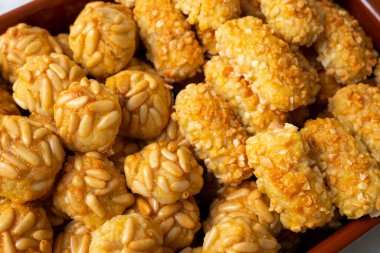 Penellets. Small sweets of various shapes, made from almond and potato dough, and covered with almonds or pine nuts.