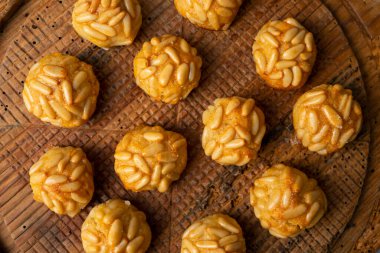 Penellets. Small sweets of various shapes, made from almond and potato dough, and covered with almonds or pine nuts.