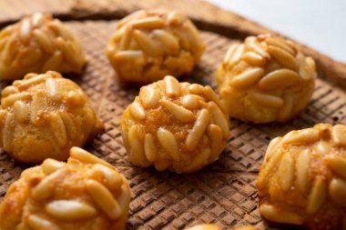 Penellets. Small sweets of various shapes, made from almond and potato dough, and covered with almonds or pine nuts.