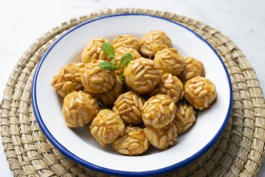 Penellets. Small sweets of various shapes, made from almond and potato dough, and covered with almonds or pine nuts.