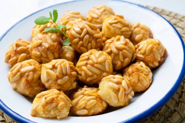 Penellets. Small sweets of various shapes, made from almond and potato dough, and covered with almonds or pine nuts.