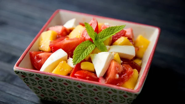 stock image Delicious salad with mango and tomatoes.