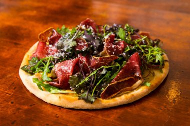 Pizzalı carpaccio. Domates soslu, peynirli ve biftekli Napoli pizzası. İtalyan tarifi.