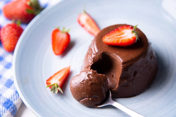 Chocolate Panna Cotta. Panna cotta is a typical dessert from the Italian region of Piedmont, made from milk or cream, sugar and gelling agents, which is usually garnished with red fruit jams.