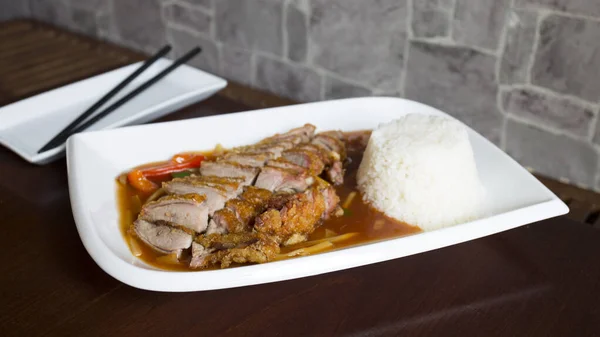 stock image                 Asian combo plate with roast duck and rice.               