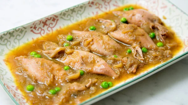 Stock image Stewed squid with tomato and onion sauce. Traditional Spanish tapa.