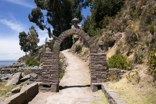 Stone heads carved into the arches on the island of Taquile on Lake Titicaca in Peru.