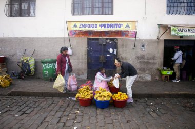 Cusco Peru, 1 Ocak 2023: Peru 'nun merkez pazarı çevresinde sebze ve meyve satan yerliler.