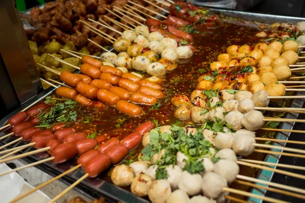 Fried fish starters at a street food stall in the city of Bangkok in Thailand..