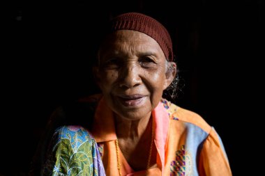 Koh Yao, Tayland; 1 Ocak 2023: Yaşlı kadın kurutulmuş palmiye yapraklarından sepet yapıyor.