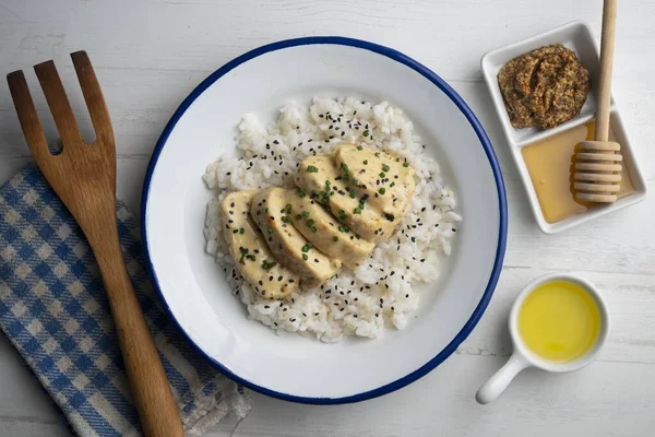 Chicken cooked with honey mustard sauce served over white rice.