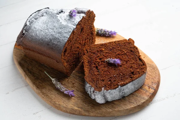 Chocolate cake with orange and some lavender flowers to decorate.