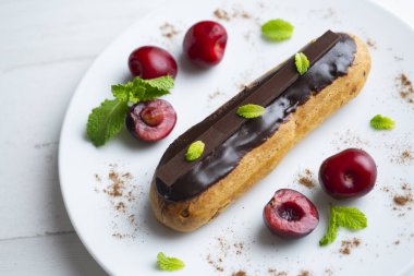 Çikolata kremalı Fransız ekleri. ve taze kirazla servis edilir..