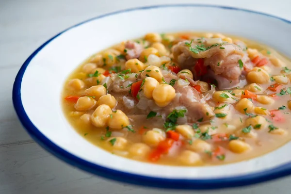 Stewed chickpeas with pig\'s feet. Traditional recipe from northern Spain.