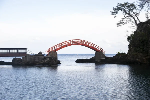 Red bridge conecting volcanic rock formations in Sado Island in Yajima and Kyojima.