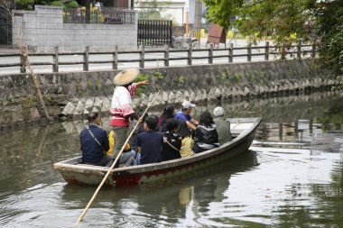 Yanagawa, Japonya; 10 Ekim 2023: Fukuoka 'daki Yanagawa şehrinin yetenekli kayıkçılar tarafından işletilen tekneleriyle birlikte gezmek için güzel kanalları vardır..
