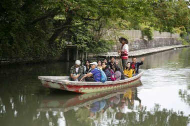 Yanagawa, Japonya; 10 Ekim 2023: Fukuoka 'daki Yanagawa şehrinin yetenekli kayıkçılar tarafından işletilen tekneleriyle birlikte gezmek için güzel kanalları vardır..