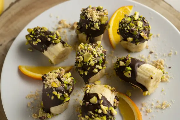 Koyu çikolata ve şam fıstığı kaplı muz parçaları..