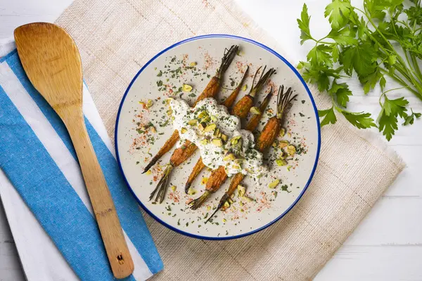 Stock image Oven roasted carrots with Italian burrata and pistachios.