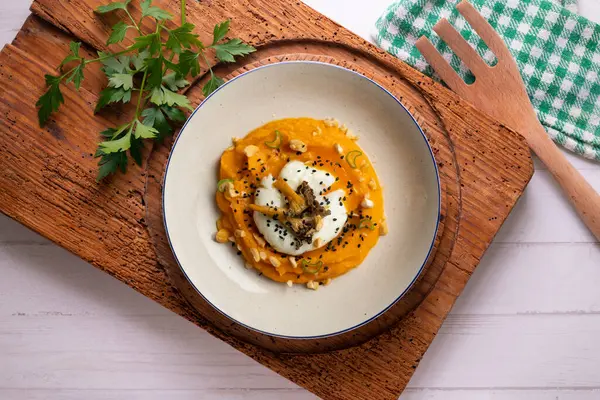 stock image Sweet potato cream with poached egg and mushrooms. Top view table.