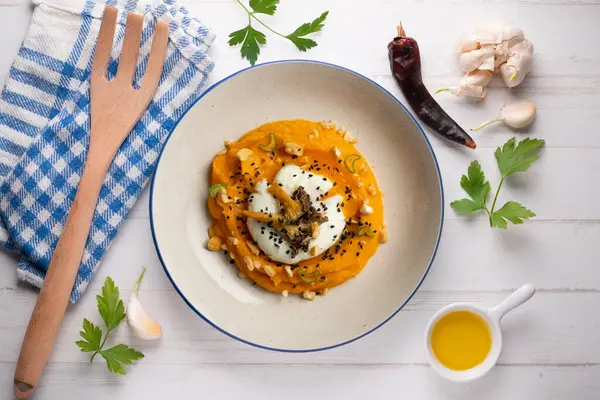 stock image Sweet potato cream with poached egg and mushrooms. Top view table.