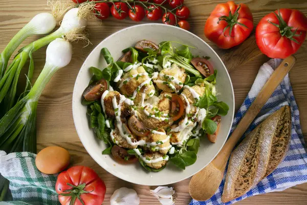 Kızarmış karnabahar salatası ve sebze ve yoğurt sosu. Üst manzara yemek masası.