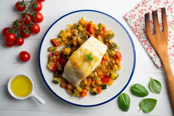 stock image Cod with baked vegetables traditional Spanish recipe. Top view food table.