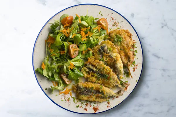 stock image Battered anchovies, traditional Spanish tapa from the Malaga area. Top view table.