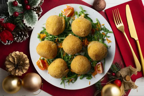 stock image Spanish Tapa croquettes made with bechamel sauce and stuffed with iberian ham. Top view table with christmas decoration.