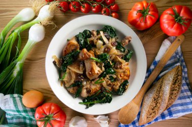 Ispanak ve kuru üzümle pişirilmiş lezzetli tavşan. Üst görünüm tablosu