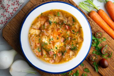 Castilian soup with vegetables, bread croutons and egg. Top view table with  decorations. clipart